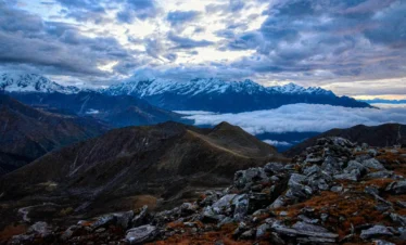 View from Danphebhir La on Uttarey–Singalila Circuit Trek with snow-capped Himalayas and cloud-covered valleys