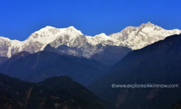 Snow-capped Kanchenjunga mountain viewed from Pelling in West Sikkim under a clear blue sky.