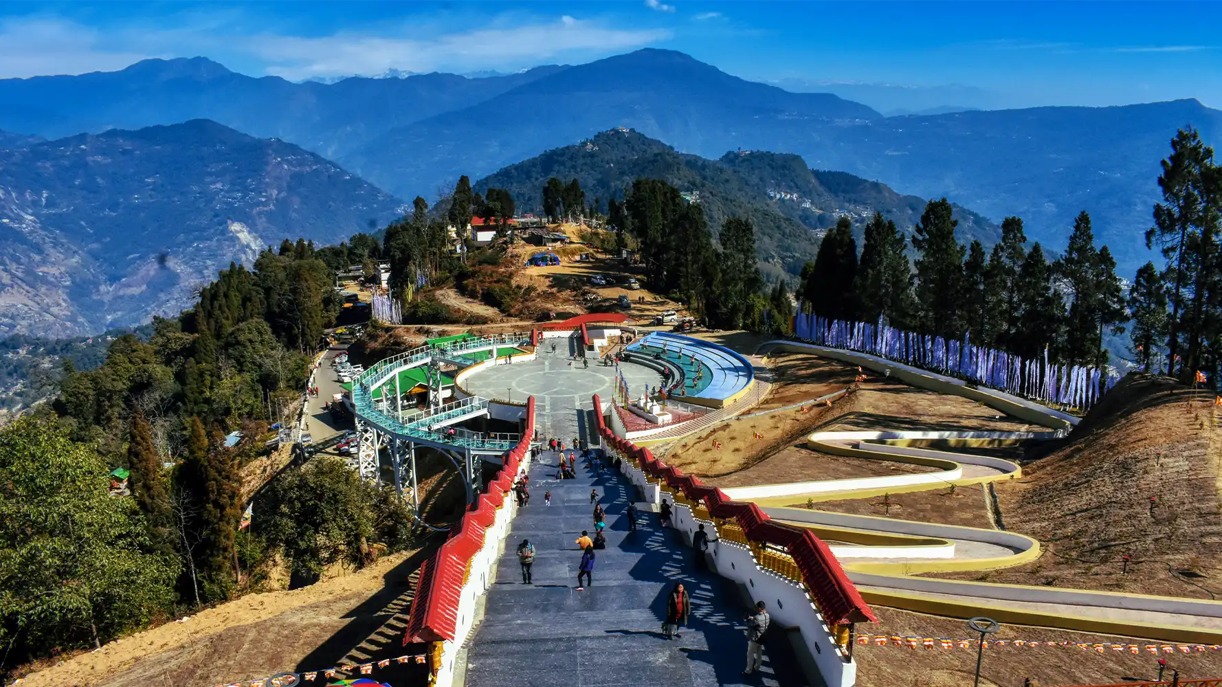 Scenic view of Pelling Skywalk in West Sikkim overlooking hills, trees, and layered Himalayan landscapes.